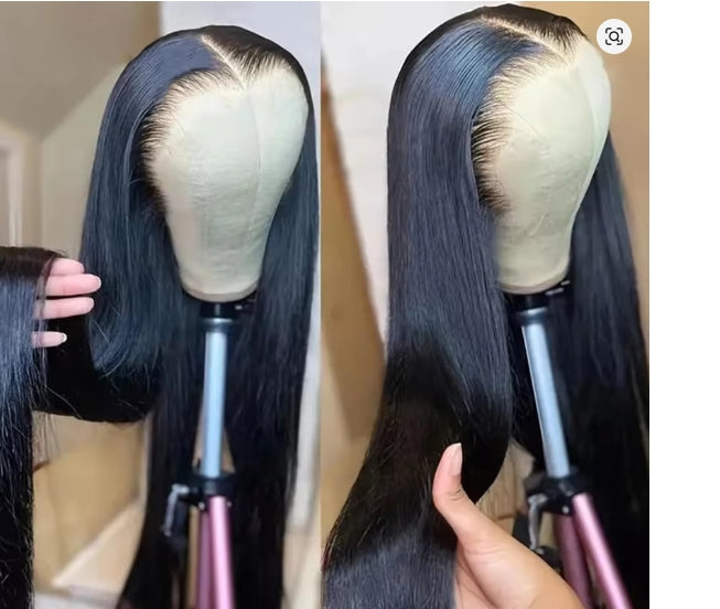 Black lace front wig on a mannequin head with a hand adjusting the hair, against a neutral background.